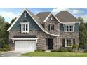 Charming two-story home with stone and siding facade, well-maintained landscaping, and an attached two-car garage at 3050 Tramore Dr, Harrisburg, NC 28075