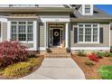 Detailed view of the home's entrance, highlighting the welcoming porch and landscaping at 315 Muirfield Way, Salisbury, NC 28144