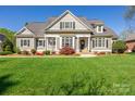 Attractive home with a manicured lawn, neutral siding, dark shutters, and a welcoming entrance at 315 Muirfield Way, Salisbury, NC 28144