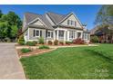 Well-maintained home with lush landscaping, neutral siding, dark shutters, and a pristine lawn at 315 Muirfield Way, Salisbury, NC 28144