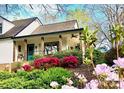 Charming home with a cozy front porch framed by colorful flowers and landscaping at 3707 Banyon Nw Ct, Concord, NC 28027