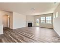 Bright living room with hardwood floors, a fireplace, and a door leading to the outside at 4171 Skyboat Cir, Fort Mill, SC 29715