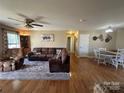 Spacious living room featuring hardwood floors, ceiling fan and comfortable seating at 52 Restful Ln, Hickory, NC 28601