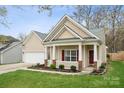 Inviting single-story home with a cozy front porch and a well-maintained lawn at 5386 Josephine Sw Ln, Concord, NC 28027
