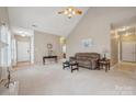 Spacious living room with a vaulted ceiling, plush carpeting, and ample natural light at 5386 Josephine Sw Ln, Concord, NC 28027