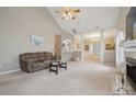 Open-concept living room with high ceilings, a fireplace, and neutral carpeting at 5386 Josephine Sw Ln, Concord, NC 28027