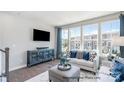 Comfortable living room featuring large windows and chic furnishings and decor at 6029 Fonsac Ln # 2008C, Charlotte, NC 28217