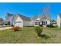 Well-kept single-Gathering home boasts an attached garage, manicured lawn, and inviting curb appeal at 6821 Parkers Crossing Dr, Charlotte, NC 28215