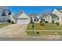 Inviting single-Gathering home with lush lawn, attached garage, and charming architectural details at 6821 Parkers Crossing Dr, Charlotte, NC 28215