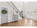 Grand two-story foyer with hardwood floors and elegant staircase, creating an impressive entrance at 7313 Glenroe Dr, Huntersville, NC 28078