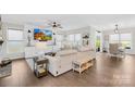 Open concept living room featuring a large sofa, a flat-screen TV, and access to the backyard at 7313 Glenroe Dr, Huntersville, NC 28078