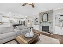 Bright living room boasts a stone fireplace, hardwood floors, and seamless flow to the kitchen at 7313 Glenroe Dr, Huntersville, NC 28078