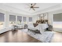 Expansive main bedroom with tray ceilings, large windows, and cozy seating area at 7313 Glenroe Dr, Huntersville, NC 28078