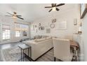 Spacious living room with ceiling fans, neutral walls, and views of the dining area at 816 Gentlewinds Ct, Fort Mill, SC 29708