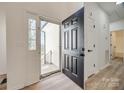 Bright entryway featuring new wood flooring and a black front door leading outside at 937 Brooklee Dr, Kings Mountain, NC 28086