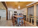 Modern kitchen featuring stainless steel appliances, island seating, and stylish pendant lighting at 938 Pinehaven Dr, New London, NC 28127