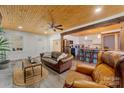 Inviting living room with wood ceiling, fireplace and open layout, seamlessly connecting to the kitchen at 938 Pinehaven Dr, New London, NC 28127