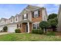 Beautiful two-story home with stone accents, complemented by lush landscaping and a well-maintained lawn at 10241 Barrands Ln, Charlotte, NC 28278