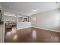Spacious living room with hardwood floors, adjacent to a comfortable seating area and great natural light at 10241 Barrands Ln, Charlotte, NC 28278