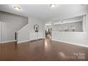 Open-concept living area boasts hardwood floors and neutral paint, perfect for entertaining and relaxation at 10241 Barrands Ln, Charlotte, NC 28278