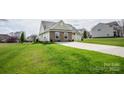 Well-kept single-Gathering home with a spacious yard, long driveway, and appealing stone and siding exterior at 118 Heathrow Ln, Statesville, NC 28677