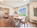 Bright dining room featuring a wooden table with six chairs, large window, and modern decor at 12140 Devon Square Ct, Charlotte, NC 28262