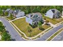 Aerial view of home with landscaped front yard in quiet neighborhood at 1276 Stonecrest Blvd, Tega Cay, SC 29708