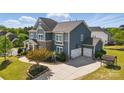 Two story home with two car garage, driveway and meticulously landscaped yard at 1276 Stonecrest Blvd, Tega Cay, SC 29708