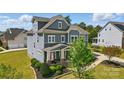 Beautiful home with manicured lawn and landscaping; features an American flag at 1276 Stonecrest Blvd, Tega Cay, SC 29708