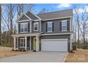 Two-story home features gray siding, black shutters, a two-car garage, and a bright green front door at 130 Big Oak Ln, Statesville, NC 28625