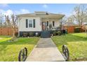 Charming home with inviting porch, black shutters, and well-manicured lawn at 1411 Congress St, Gastonia, NC 28054