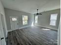 Bright living room featuring new laminate flooring, modern ceiling fan, and ample natural light at 144 Walnut St, Chester, SC 29706