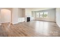Bright living room with fireplace, modern flooring and large windows for ample natural light at 1557 Croydon St, Indian Land, SC 29707