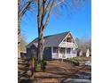 Beautiful home exterior with a large front yard and 'For Sale' sign, ideal for those seeking comfort and style at 1703 Polk St, Monroe, NC 28110