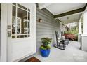 Close up of a front porch with rocking chairs, a hanging porch swing, and an inviting entrance at 1717 Thomas Ave, Charlotte, NC 28205