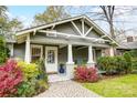 Inviting front porch with white pillars, rocking chairs, and colorful plants framing the entrance at 1717 Thomas Ave, Charlotte, NC 28205