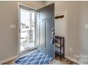 Welcoming entryway with a stylish rug, coat hooks and view of the neighborhood at 1986 Thoreau Way, York, SC 29745