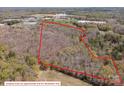 Aerial view of wooded property with approximate property lines overlaid in red at 2018 Fox Creek Trl, Lincolnton, NC 28092