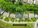 An aerial view of the property showcasing its location surrounded by lush greenery and neighboring houses in a suburban setting at 20827 Brinkley St, Cornelius, NC 28031