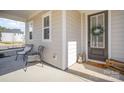 Cozy front porch with seating and a welcoming wreath on the front door at 2105 Moss Bluff Dr, Mint Hill, NC 28227