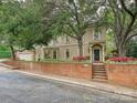 Charming home exterior with brick landscaping, mature trees, and a well-manicured lawn at 2132 Rolston Dr, Charlotte, NC 28207