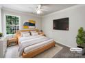 Modern bedroom showcasing a comfortable bed, stylish decor, and a ceiling fan at 3711 Cole Mill Rd, Charlotte, NC 28270