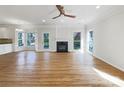 Open living room boasts a fireplace, hardwood floors, and plenty of natural light at 3711 Cole Mill Rd, Charlotte, NC 28270