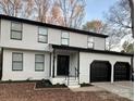 Charming two-story home featuring a black roof, white siding, and a two-car garage at 4427 Gaynelle Dr, Charlotte, NC 28215