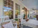 Inviting front porch with rocking chairs, ceiling fans, and wood accents at 4912 Kenbury Ct, Fort Mill, SC 29708