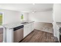 Open kitchen with granite countertops, stainless steel dishwasher, and a view to the living room at 502 Maddox Dr, Shelby, NC 28152