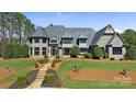 Stunning stone home with lush lawn, elegant landscaping, and a stone walkway at 525 Lake Lynn Rd, Concord, NC 28025
