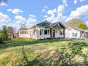 Exterior view of the home showing well-kept lawn and pleasant neighborhood at 703 Rankin Ave, Mount Holly, NC 28120