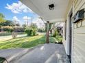Covered porch view, showcasing outdoor living space and neighborhood scenery at 703 Rankin Ave, Mount Holly, NC 28120