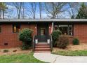 Inviting front entrance with brick steps, stylish door, and manicured landscaping adding curb appeal at 801 Glendora Dr, Charlotte, NC 28212